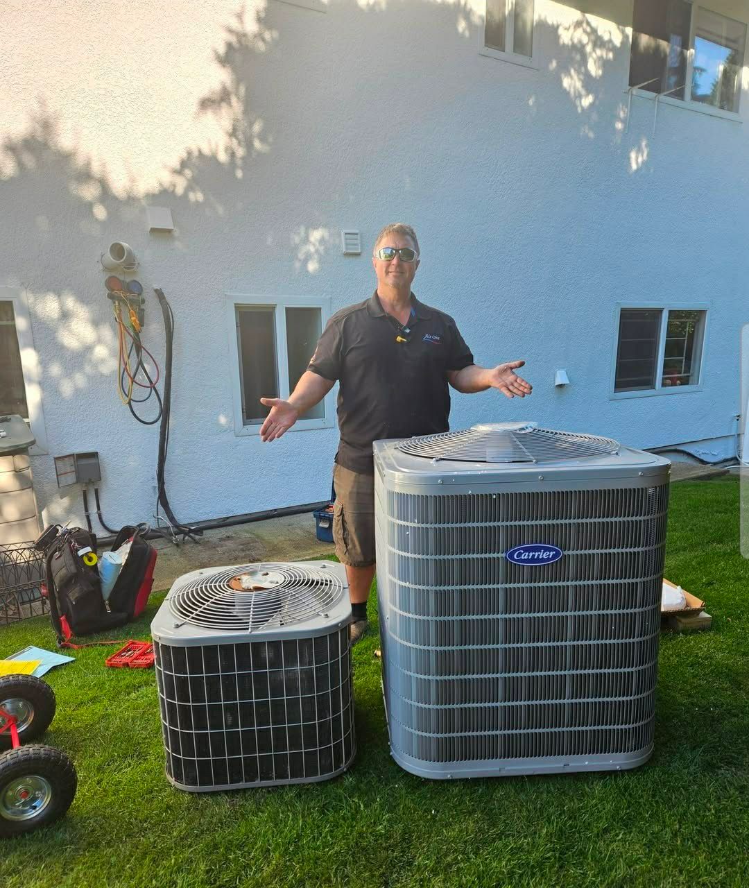 Air One technician with residential Carrier air conditioning equipment