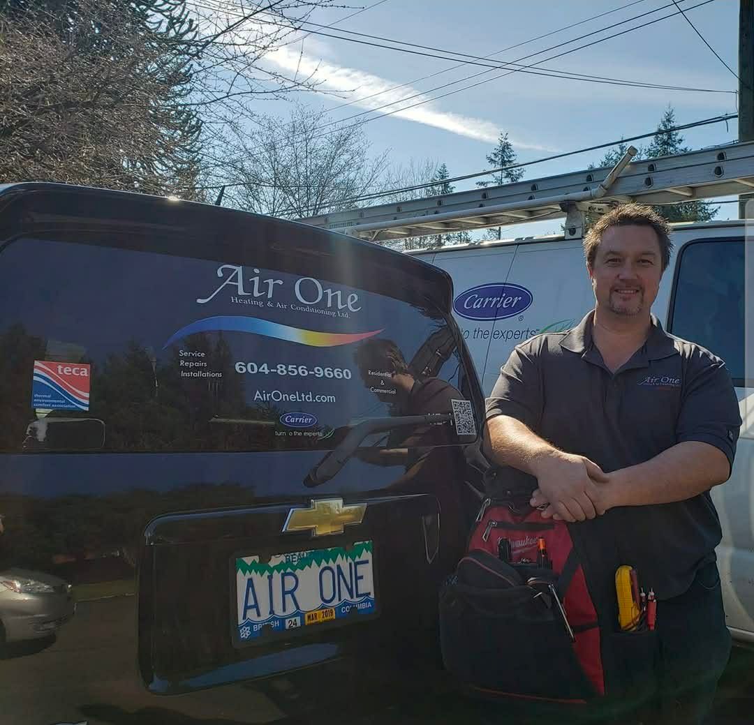 Air One technician beside the company service vehicle